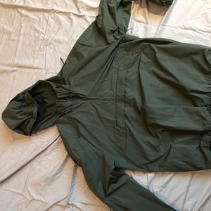 Dark green medium quarter zip rain jacket with front pocket